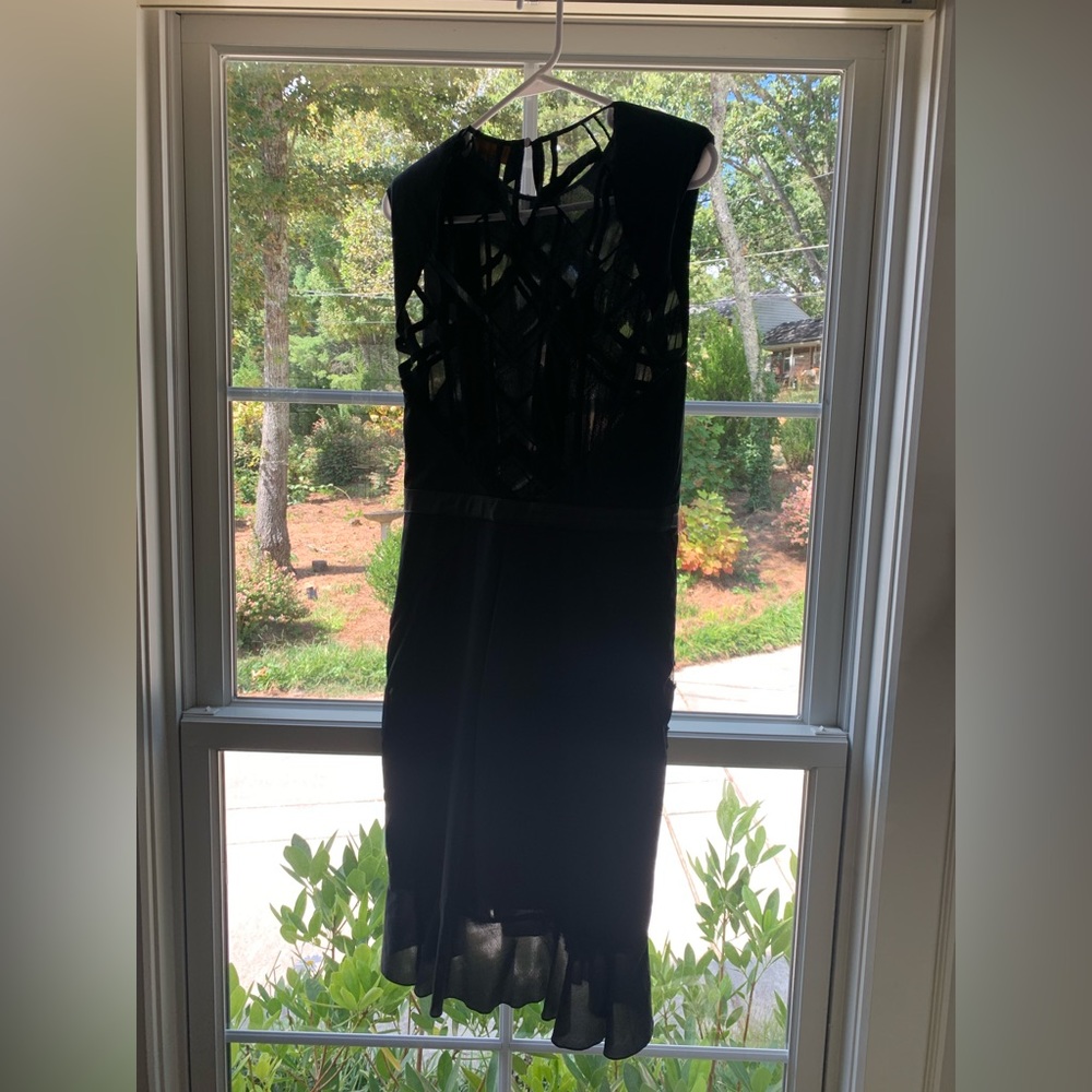 Nicole Miller black cocktail dress with sheer cutouts. Size Small.